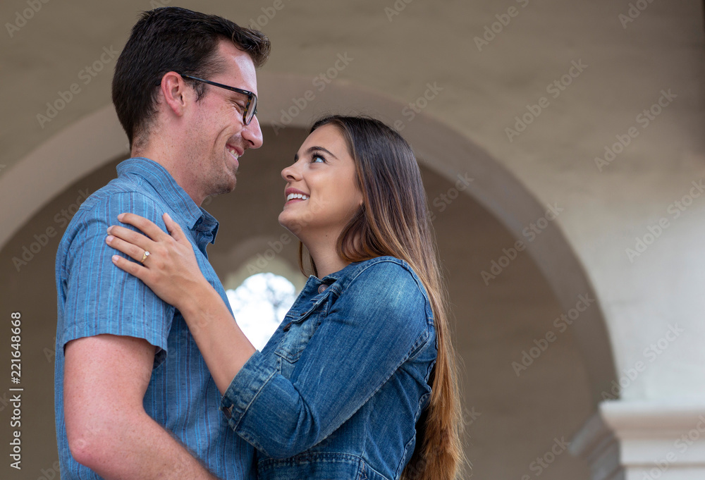 Young and loving couple tenderly embrace each other