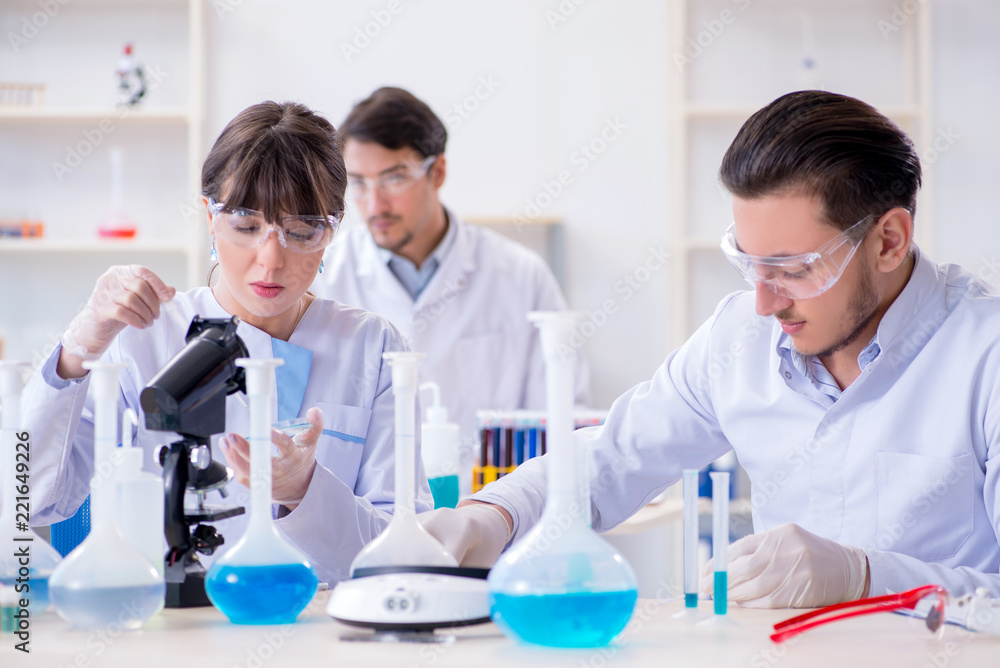 Team of chemists working in the lab Team of chemists working in the lab
