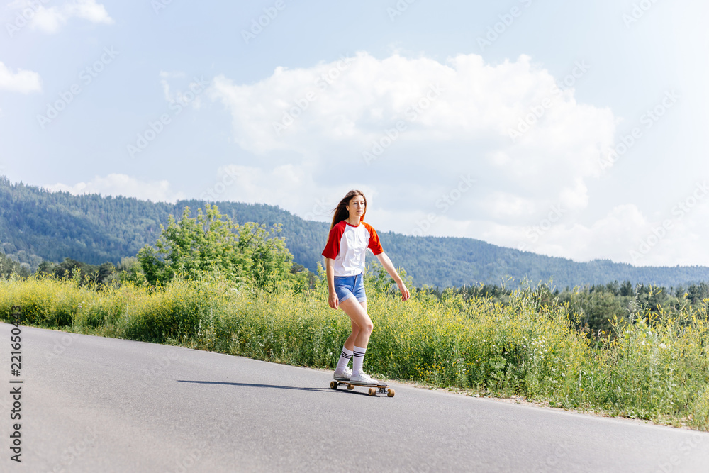 Beautiful skater woman riding on her longboard in the city Beautiful skater woman riding on her longboard in the city