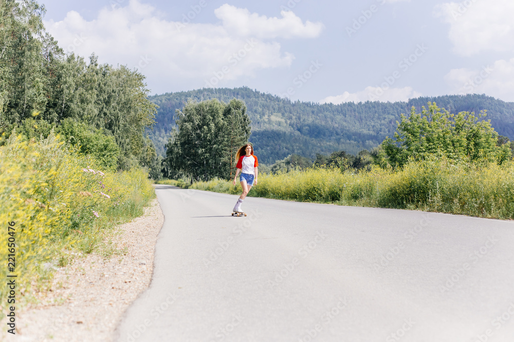 Beautiful skater woman riding on her longboard in the city