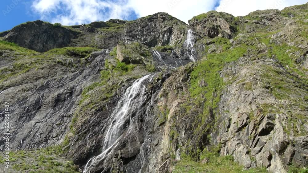 View waterfall scenes in mountains, national park Dombai, Caucasus, Russia. Summer landscape, sunshine weather, blue sky and sunny day View waterfall scenes in mountains, national park Dombai, Caucasus, Russia. Summer landscape, sunshine weather, blue sky and sunny day