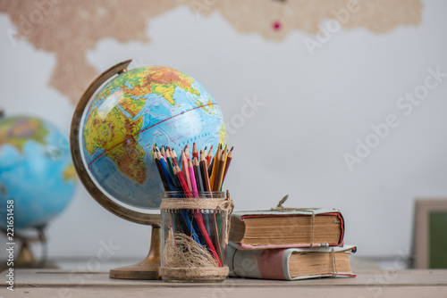 Valokuvatapetti School background, books, globe and color pencils are on the desk