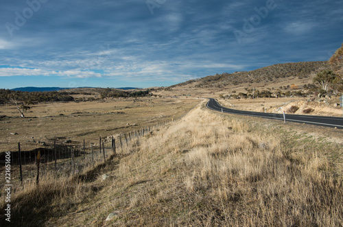 Road heading into the distance between two fields in rural australia