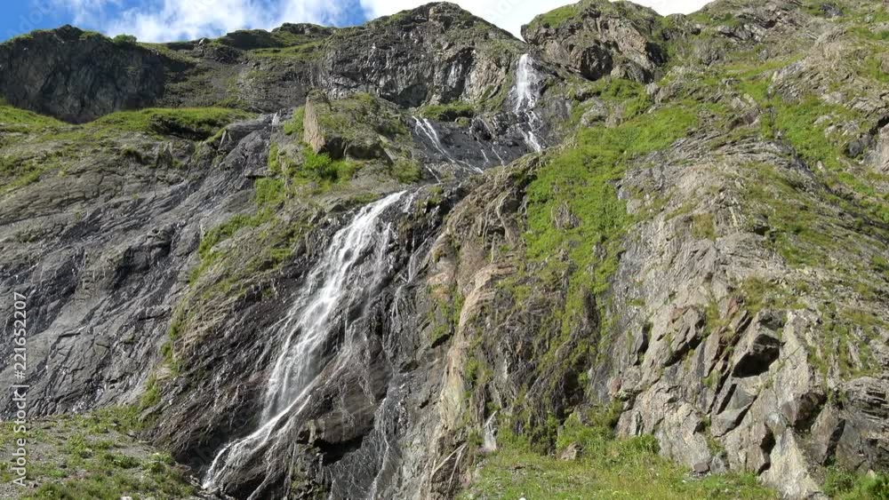 View waterfall scenes in mountains, national park Dombai, Caucasus, Russia. Summer landscape, sunshine weather, blue sky and sunny day View waterfall scenes in mountains, national park Dombai, Caucasus, Russia. Summer landscape, sunshine weather, blue sky and sunny day