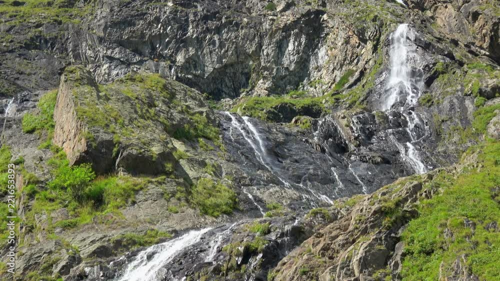 View waterfall scenes in mountains, national park Dombai, Caucasus, Russia. Summer landscape, sunshine weather and sunny day View waterfall scenes in mountains, national park Dombai, Caucasus, Russia. Summer landscape, sunshine weather and sunny day