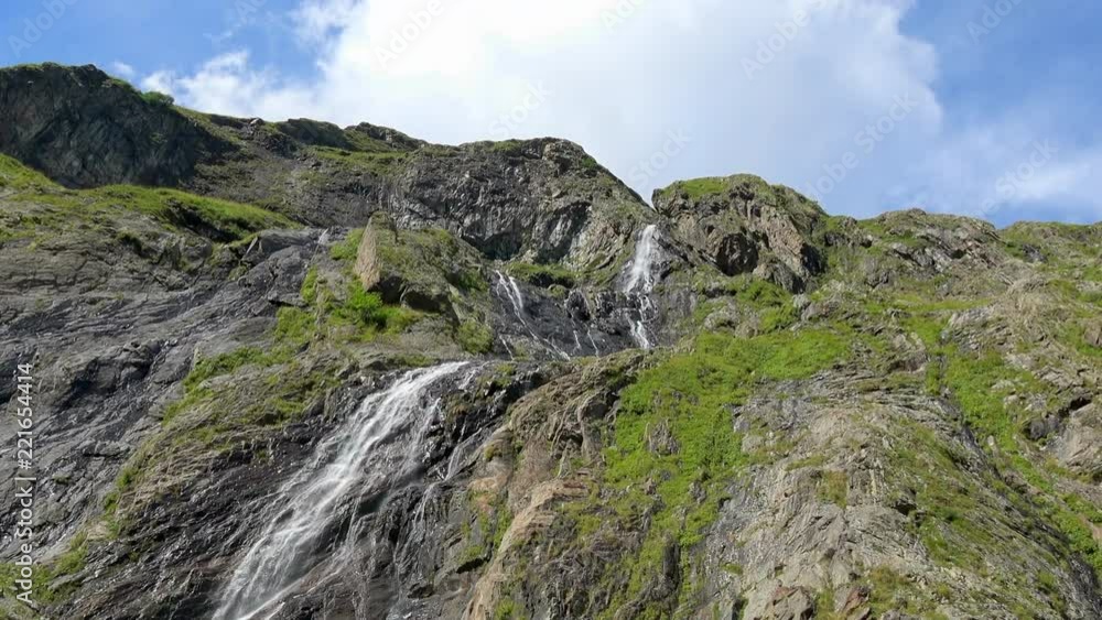 View waterfall scenes in mountains, national park Dombai, Caucasus, Russia. Summer landscape, sunshine weather, blue sky and sunny day View waterfall scenes in mountains, national park Dombai, Caucasus, Russia. Summer landscape, sunshine weather, blue sky and sunny day