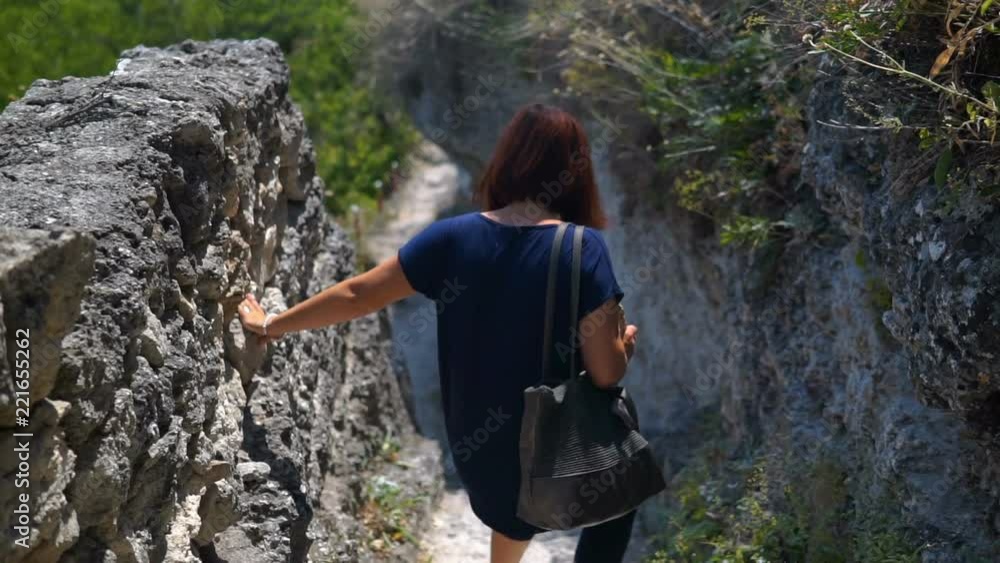 Woman Moving On Old Stone Steps Of Ancient monastery in stone Woman Moving On Old Stone Steps Of Ancient monastery in stone