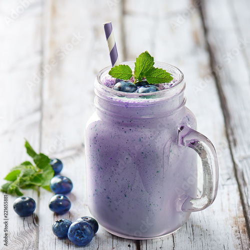 Blueberry smoothies juice a tasty healthy drink in a glass jar, drink the morning on white wooden background.