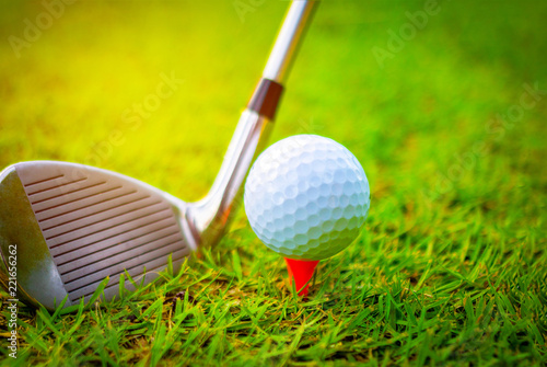 Golf ball and golf clubs on the Course. Golf ball on Orange tee. They are prepare to shot. Photo for health and game. 