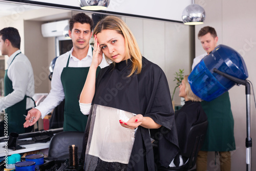 female blaming hairdresser in bad haircut