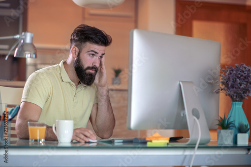 Young man studyng in living room photo