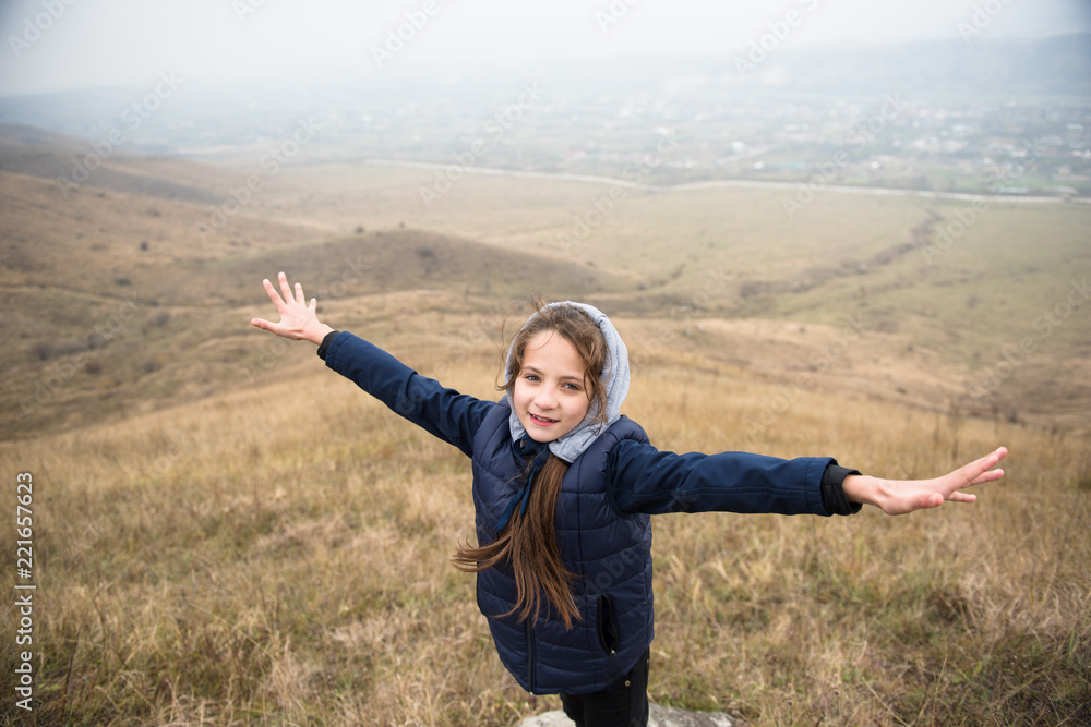 happy healthy smiling caucasian girl in jacket with hood in autumn mountain outdoor hiking happy healthy smiling caucasian girl in jacket with hood in autumn mountain outdoor hiking