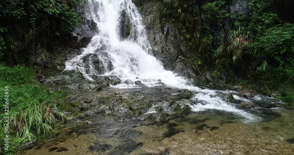 Healthy lifestyle woman doing yoga near waterfall in forest Healthy lifestyle woman doing yoga near waterfall in forest