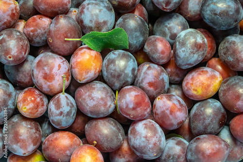 Fresh ripe red plums as a background