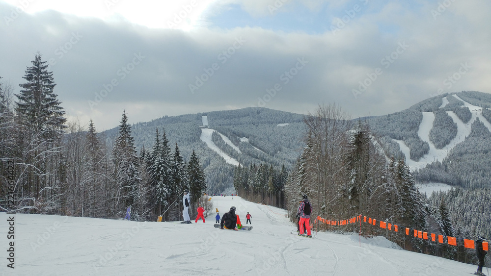 Fototapeta premium Skiers on a ski track on a beautiful sunny day in the Alps