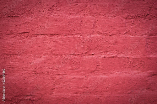 wall of brick painted red background. texture, vignette.