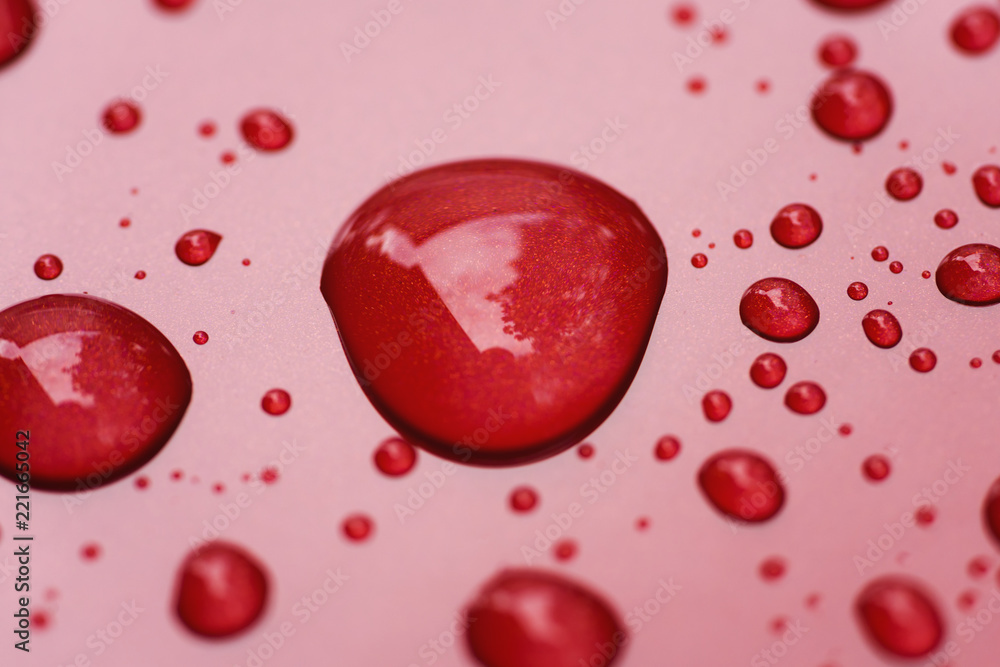 Closeup rain drops on red car with hydrophobic coating Closeup rain drops on red car with hydrophobic coating