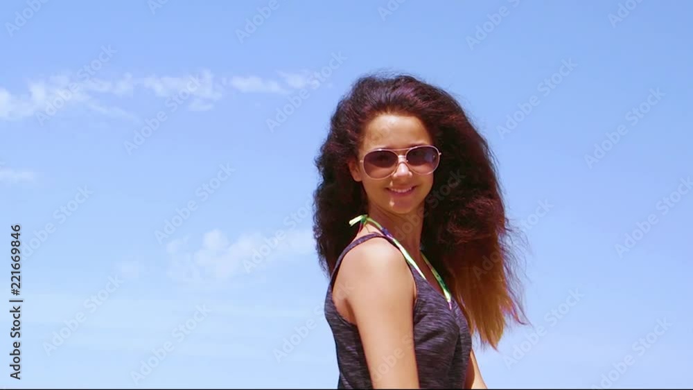 A young pretty woman with long hair dancing against the sky. Slow motion. A young pretty woman with long hair dancing against the sky. Slow motion.