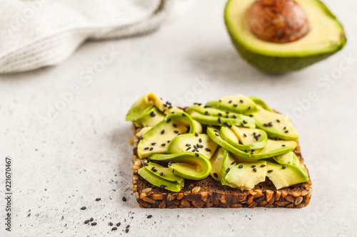 Avocado toast on a healthy sesame bread with sesame seeds, top view. Healthy vegan food concept.
