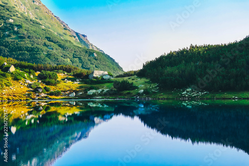 Amazing alpine lake in the high mountains. Beautiful fiord mountain, river, hiking scenic landscape, summertime.
