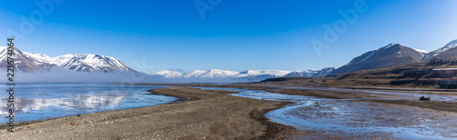 Panorama of Adventdalen surrounded by snowy mountains photo