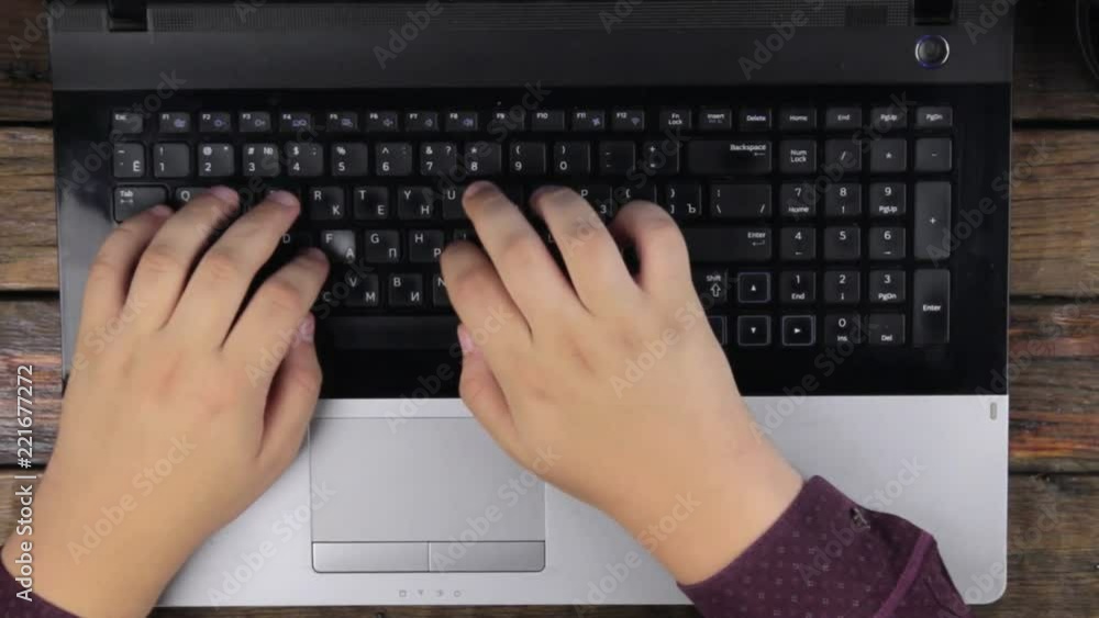 View from above. Man works on the laptop keyboard. View from above. Man works on the laptop keyboard.