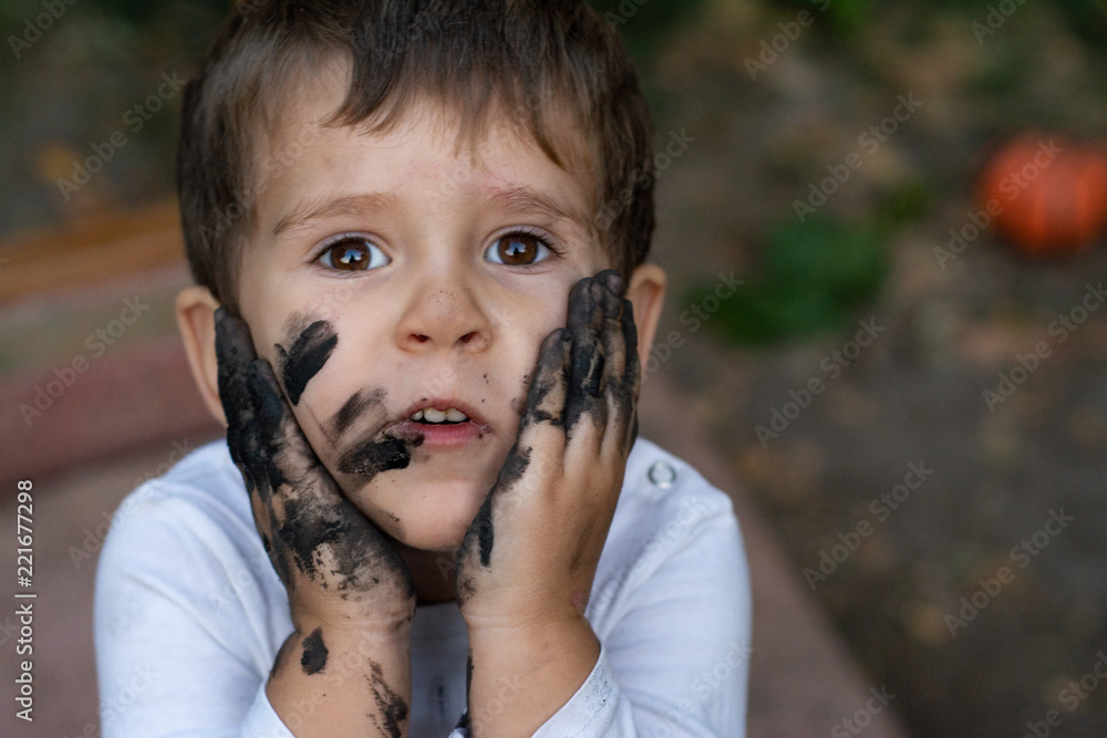 Funny kid, mud dirty face. Happy pretty kid boy playing outside with dirty  hands and face. Stock Photo | Adobe Stock