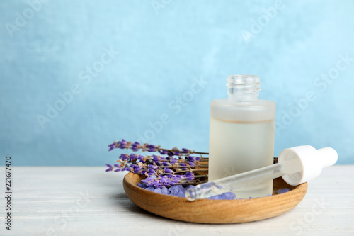 Fototapeta Naklejka Na Ścianę i Meble -  Bottle with aromatic lavender oil on wooden table. Space for text