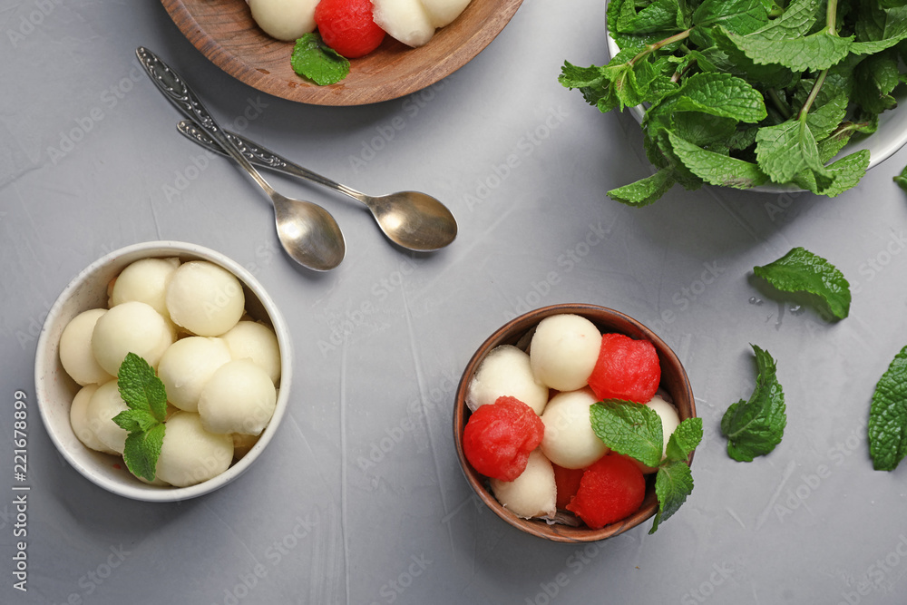 Flat lay composition with mint, melon and watermelon balls on grey background Flat lay composition with mint, melon and watermelon balls on grey background