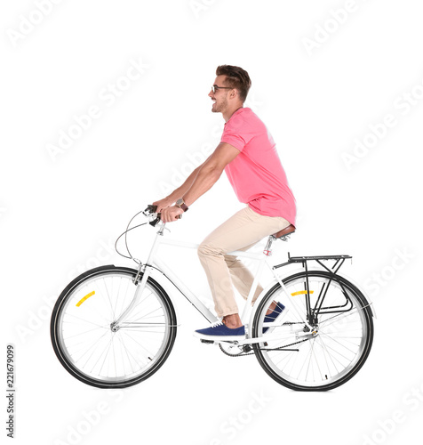 Handsome young hipster man riding bicycle on white background