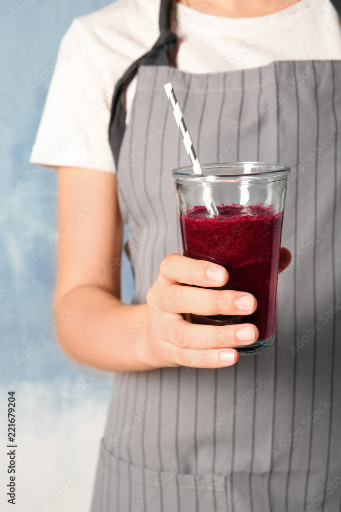 Woman with glass of beet smoothie on color background, closeup Woman with glass of beet smoothie on color background, closeup