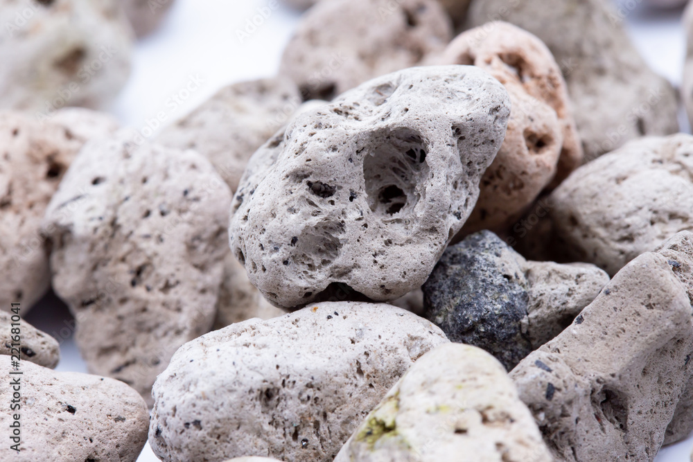 A natural piece of pumice stone isolated on white background. A natural piece of pumice stone isolated on white background.