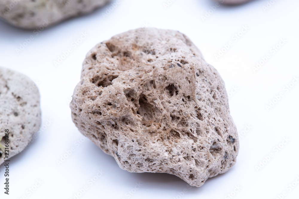 Obraz premium A natural piece of pumice stone isolated on white background.