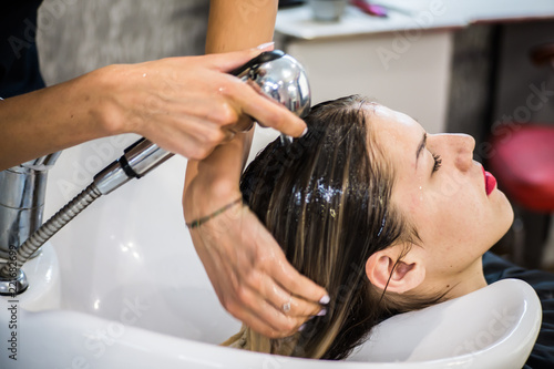 Washing the head of the client in a hairdresser's shampoo, before the hair restoration procedure, botox hair