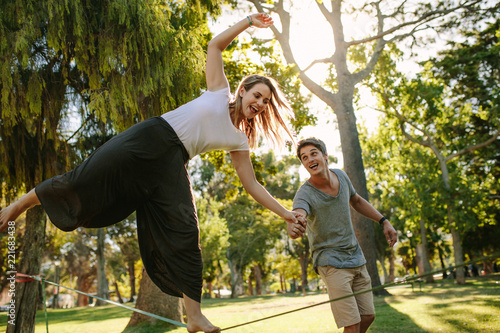 Woman practices slacklining in a park photo
