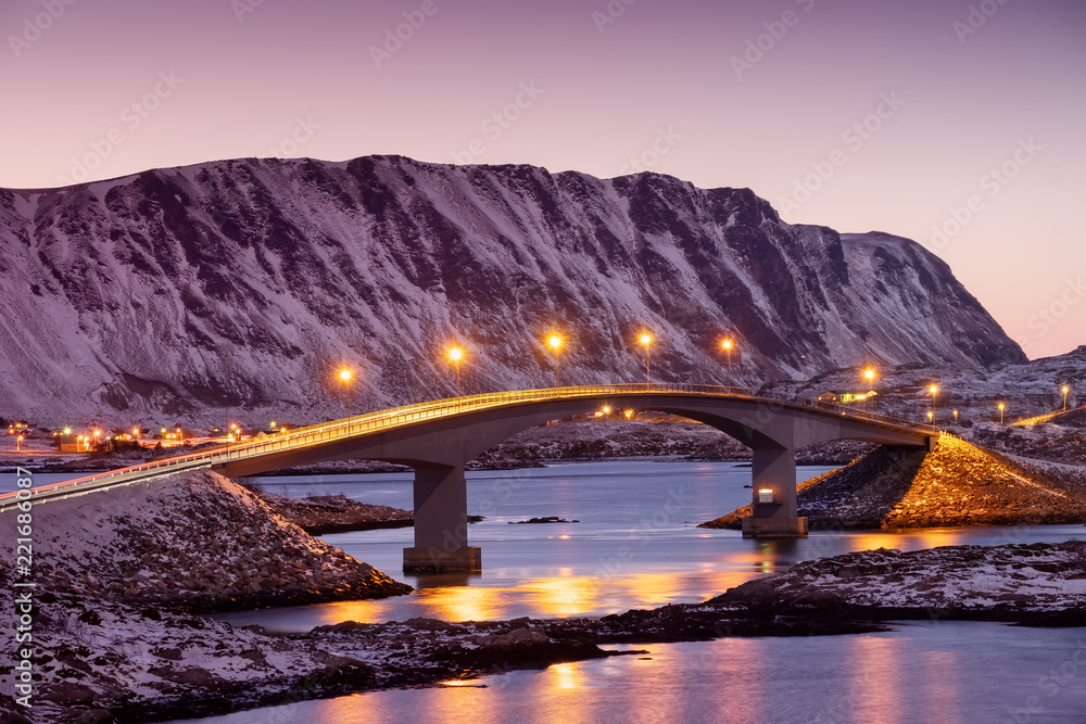 Bridge and reflection on the water surface. Natural landscape in the Lofoten islands, Norway. Architecture and landscape.