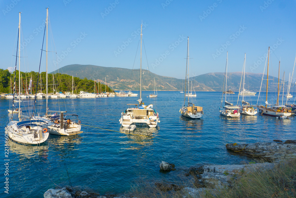 Picturesque view of the port of Fiskardo with the sailing boats on sunset in Kefalonia, Greece