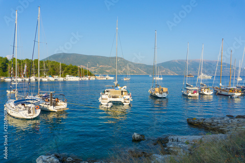 Picturesque view of the port of Fiskardo with the sailing boats on sunset in Kefalonia, Greece
