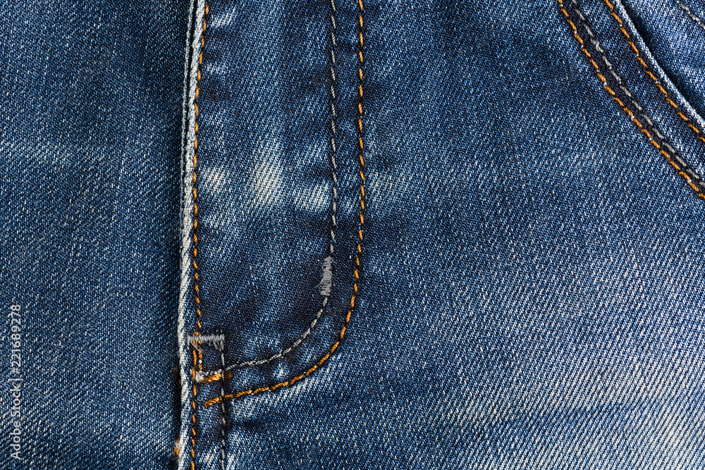 Neat stitching on the pocket of blue denim jeans Neat stitching on the pocket of blue denim jeans