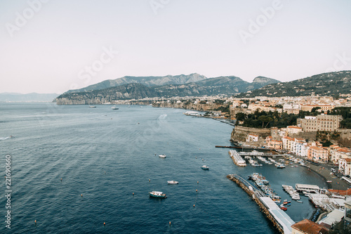 Fototapeta Naklejka Na Ścianę i Meble -  Views of the city of Sorrento in Italy, panorama and top view. Night and day, the streets and the coast. Beautiful landscape and brick roofs. Architecture and monuments of antiquity. Shops and street