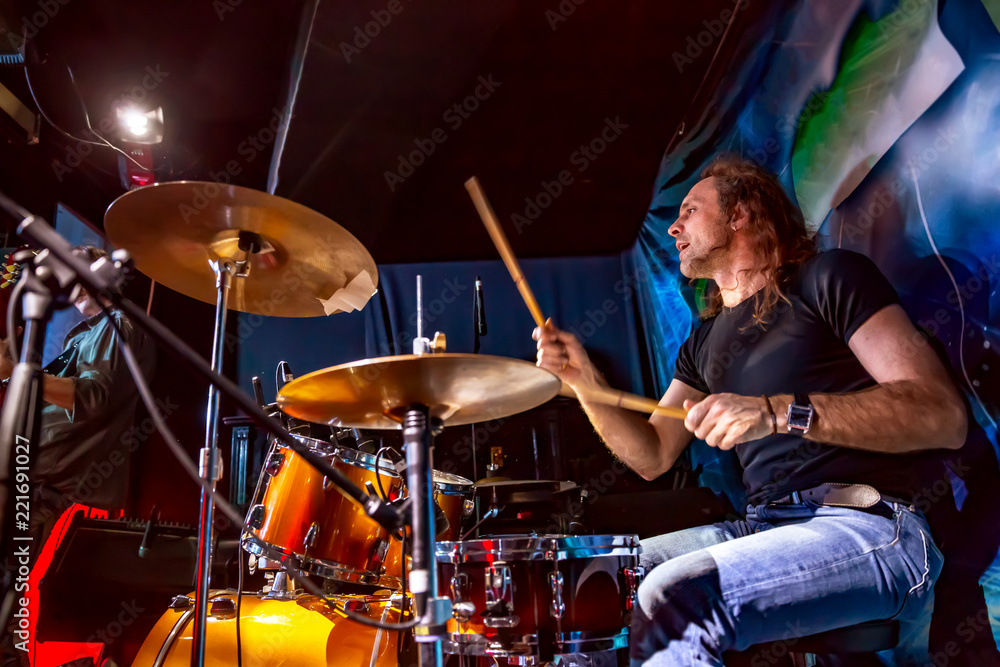 Obraz premium Drummer playing on drum set on stage.