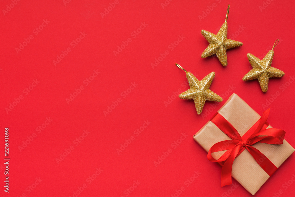 Gift box with three golden stars on red background