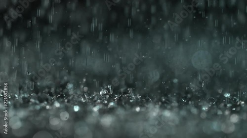 Heavy rain on dark background, shooted with high speed cinema camera at 1000 fps. 4K footage. photo