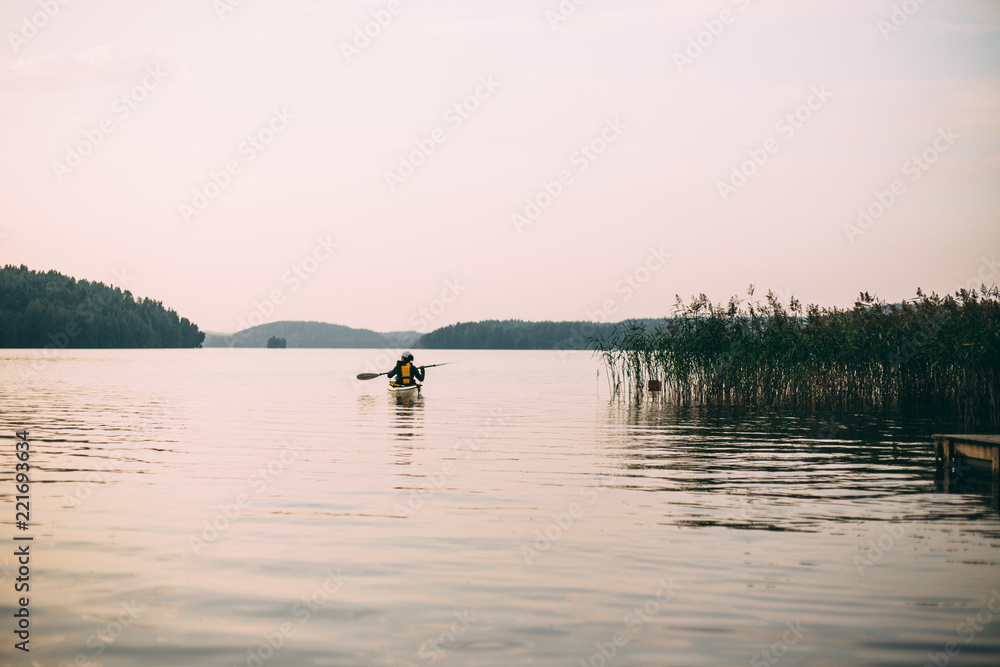 woman kayaking on the lake in Finland
