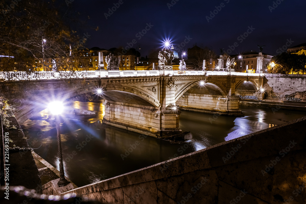 Night view of bridge over Tiber river in Rome