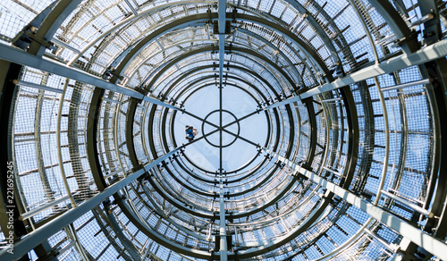 Closeup of the metalic viewing tower under a blue sky. Bottom view