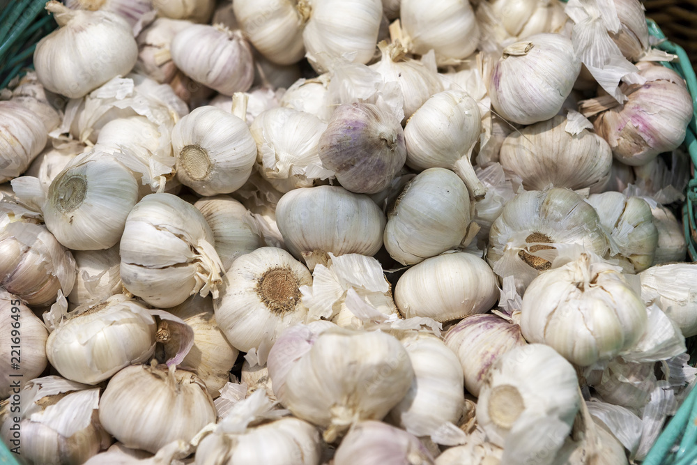 Freshly picked garlic in azure basket on market. Freshly picked garlic in azure basket on market.