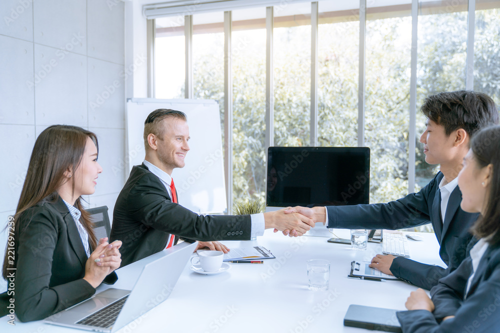 Businessman shake hands agree deal of big lot sales that finish goal of marketing plans of the company Businessman shake hands agree deal of big lot sales that finish goal of marketing plans of the company