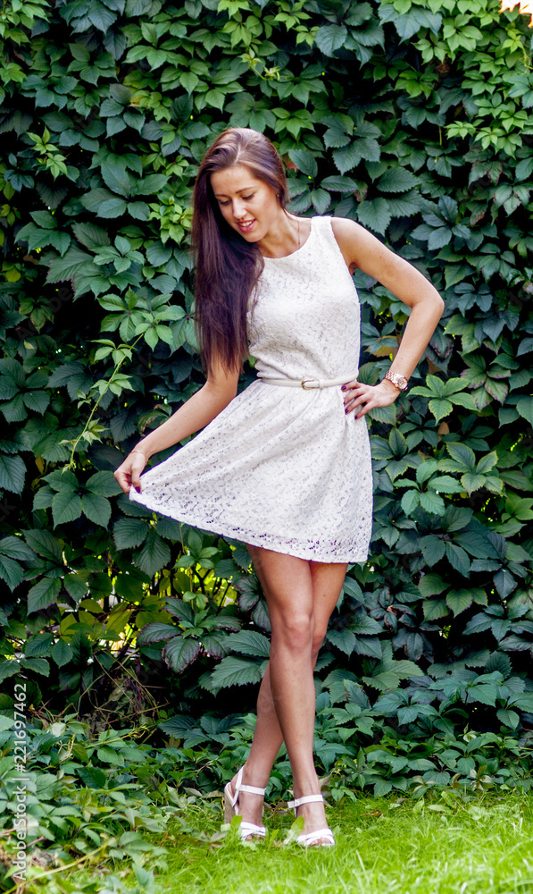 Young girl in a white dress in a summer park
Young girl in a white dress in a summer park