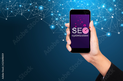 SEO optimization concept. SEO optimization on smartphone screen in businesswoman hand